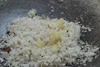 6. Dry roast fresh grated coconut. Add jaggery. Heat till jaggery softens. Switch off flame.