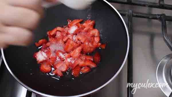 8. In a pan add strawberries, sugar and water.