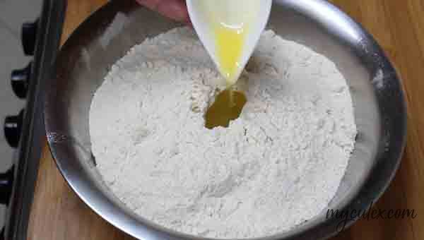 3. Add ghee to whole wheat flour in a wide bowl.