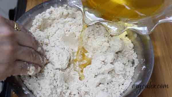 5. Now add the sugar jaggery solution little by little to the wheat flour.