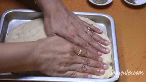 13. Flatten dough in a greased baking tray.