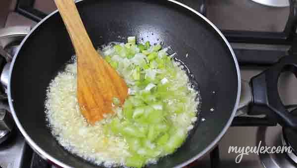 Add chopped celery. and chopped bulb parts of spring onions