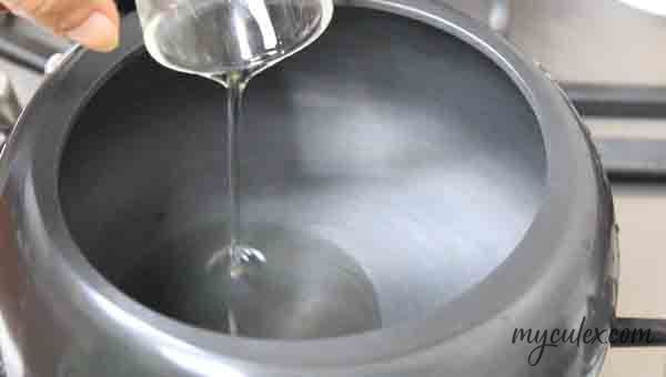 4. Pour oil in a pressure cooker.