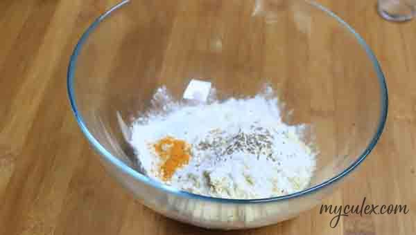 4. In a mixing bowl add gram flour, rice flour, turmeric powder, salt, baking soda, hand crushed carom seeds.