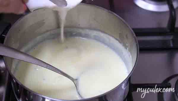11. Add badam paste to the simmering milk.