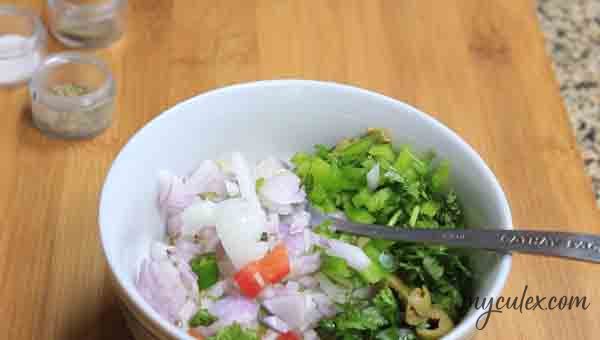 3. To this add chopped onion, chilies, chopped coriander, sliced olives and chopped bell pepper.