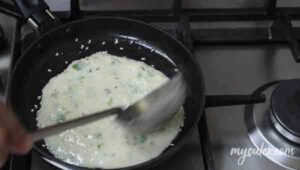 12. Pour a ladle full of uttapam batter onto the skillet.