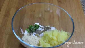 5. To this add grated potato, ground peanuts, grated roasted cumin seeds, green chili paste, salt, black pepper pdr. Mix well.