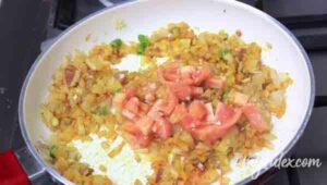 4. Add tomatoes to onion masala for seyal machhi.